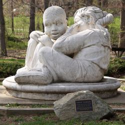sculpture of whispering couple